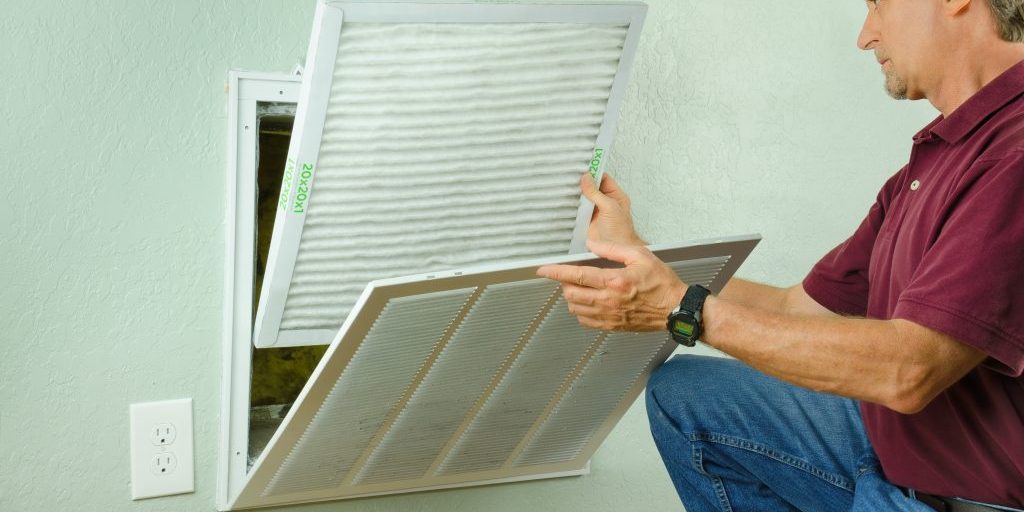 Professional repair service man or diy home owner a clean new air filter on a house air conditioner which is an important part of preventive maintenance. Mihaly Air Care - Maintenance and Care